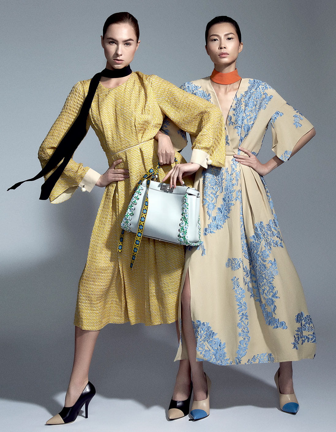 Two models pose together in head-to-toe Fendi looks