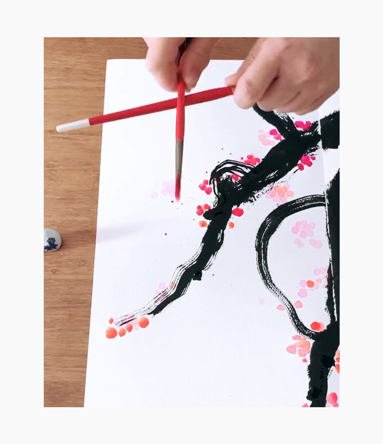 An artist creating a Chinese New Year calligraphy couplet