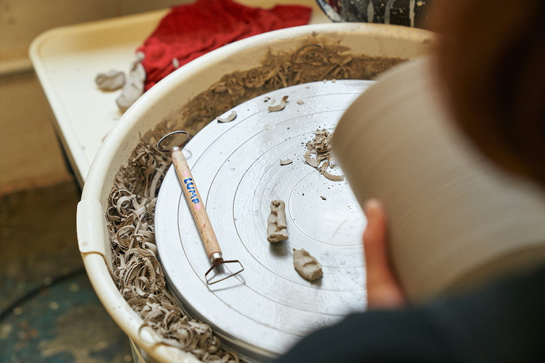 A maker works on a ceramic piece at LUMP Studio Hong Kong