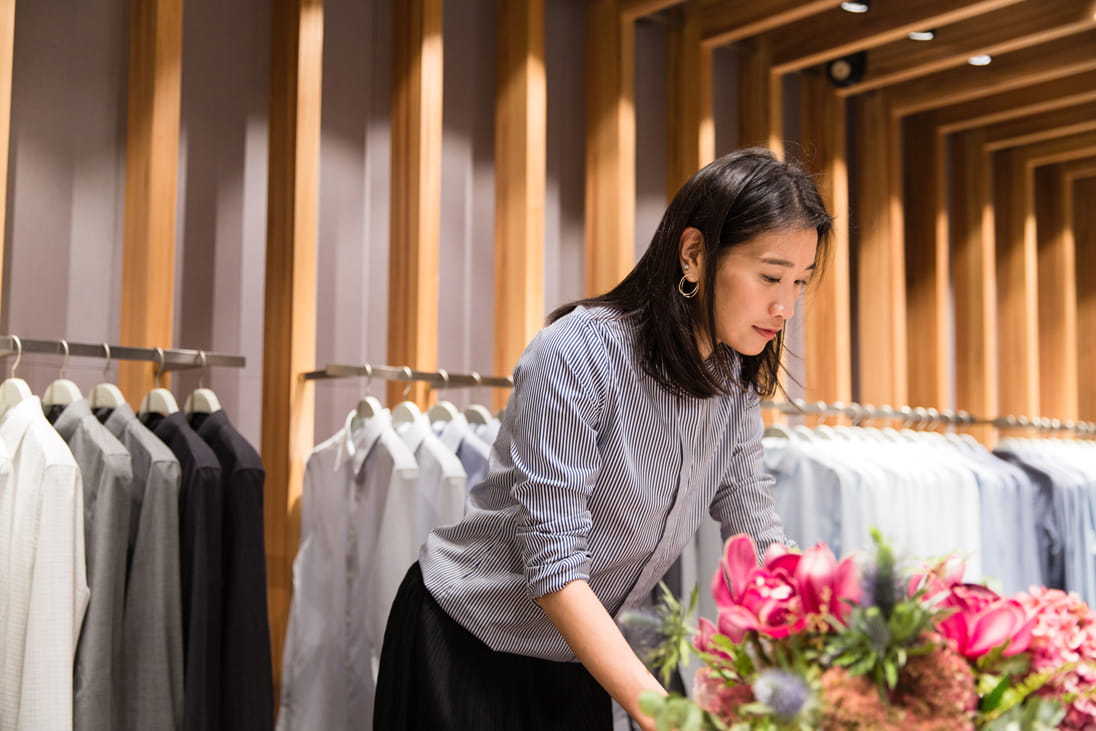 Dee adjusts merchandise at PYE’s Pacific Place store
