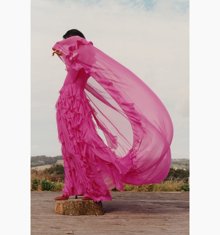 A model’s pink Valentino gown flutters in the breeze