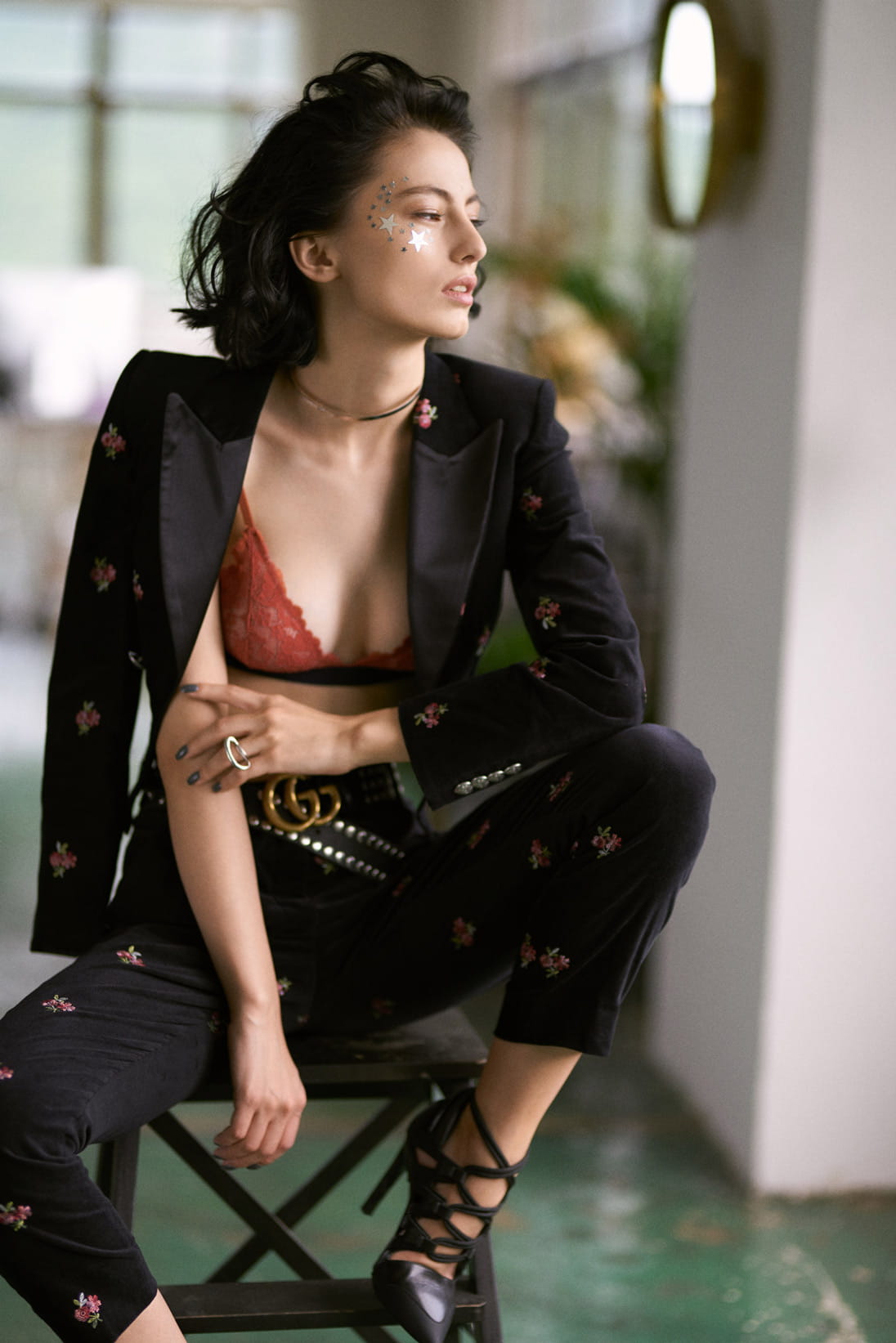 Model poses in a modern pant suit from The Kooples and bralette from COS