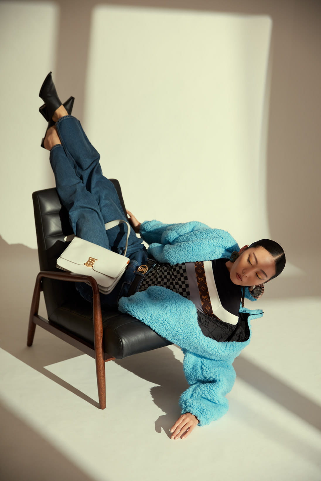 A model poses in Louis Vuitton, Balenciaga and Burberry