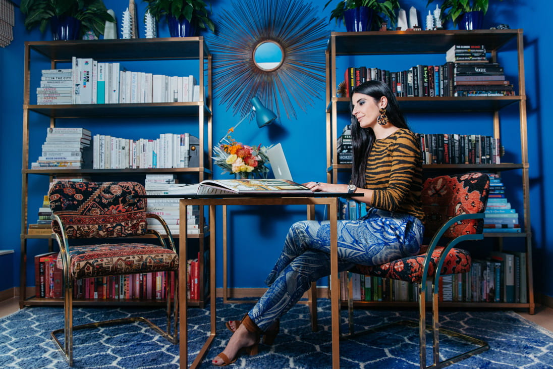 Lucia in her work space, which features an Anglepoise x Margaret Howell Special Edition Type 75 Desk Lamp and a Sequin Shimmer floral arrangement from Ellermann