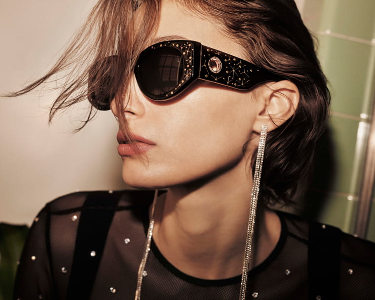 A model wearing Linda Farrow Debbie sunglasses