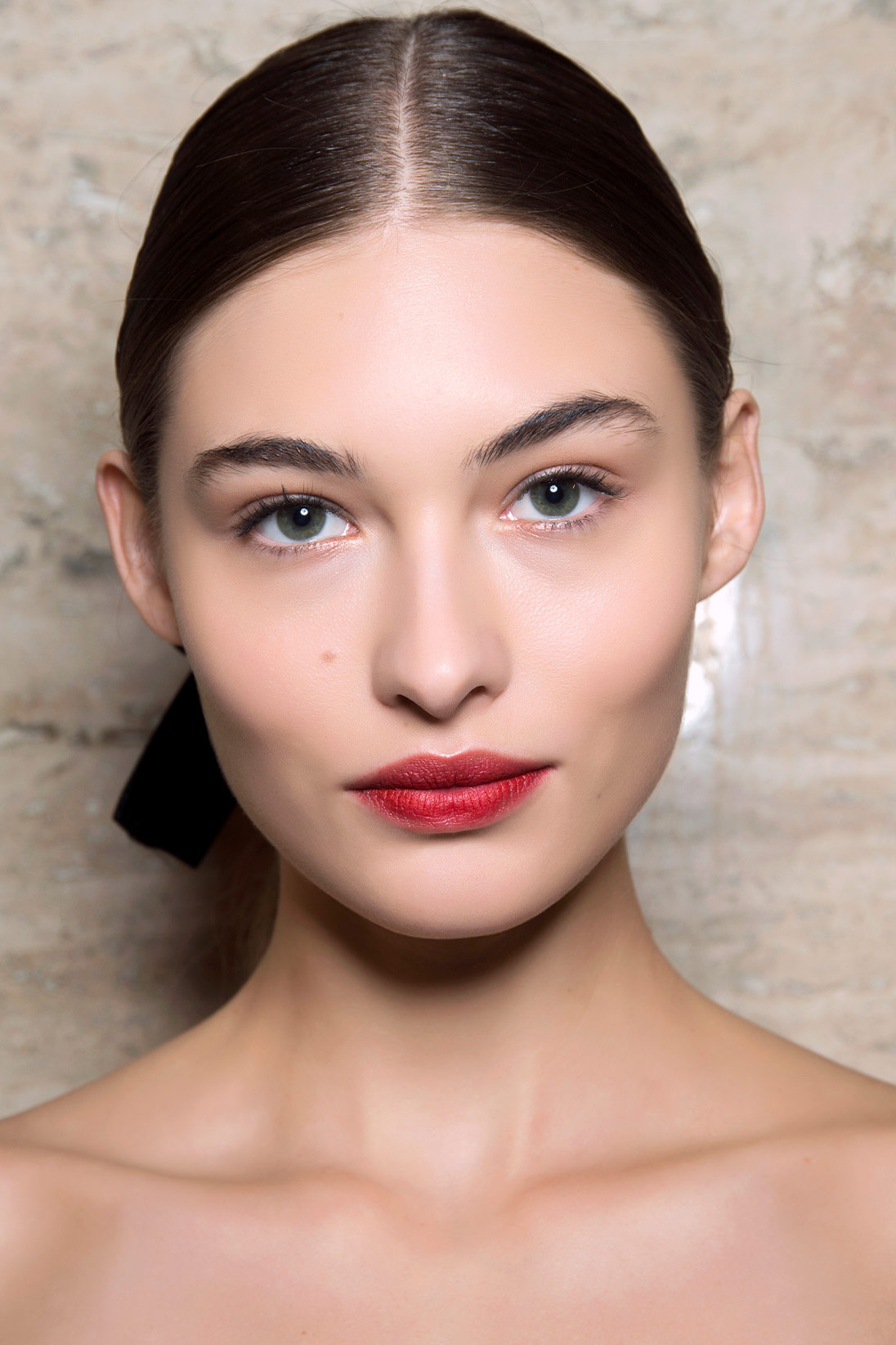 A model wearing holly red lipstick available at Pacific Place