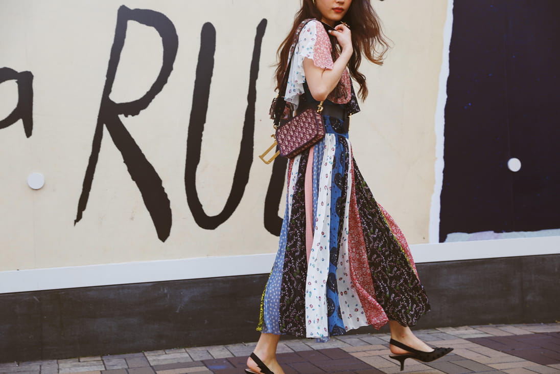 Vincci Yang walks the streets in a colourful maxi skirt and Dior bag