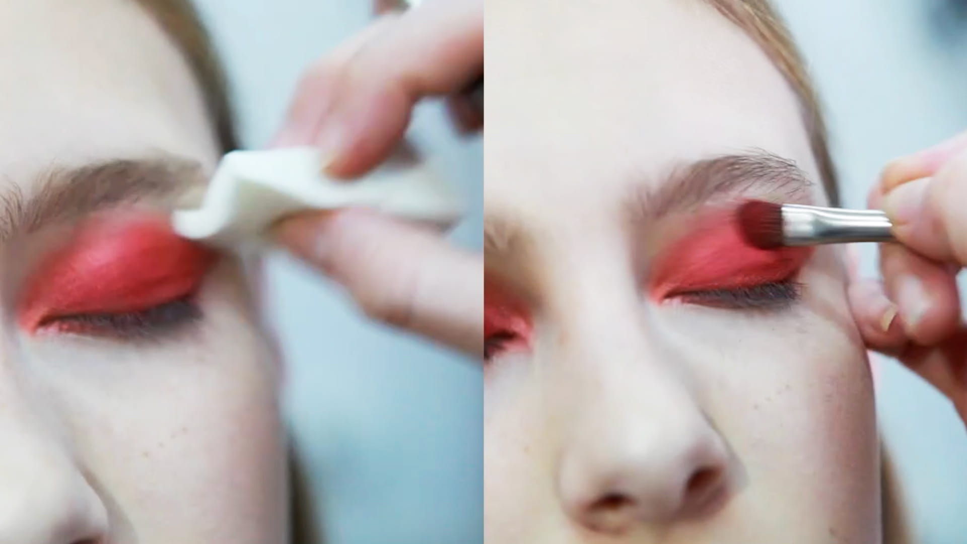 A makeup artist applies bright red eyeshadow to a model