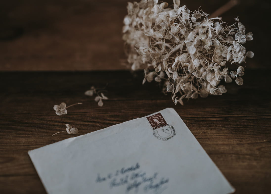 A letter next to some flowers