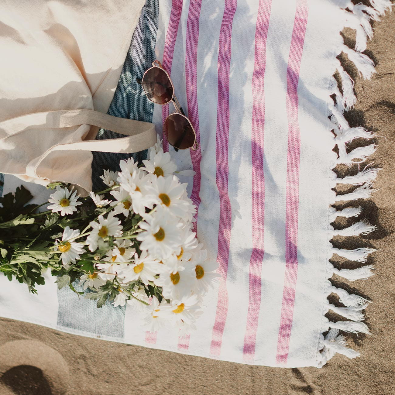 Beach items on a beach blanket