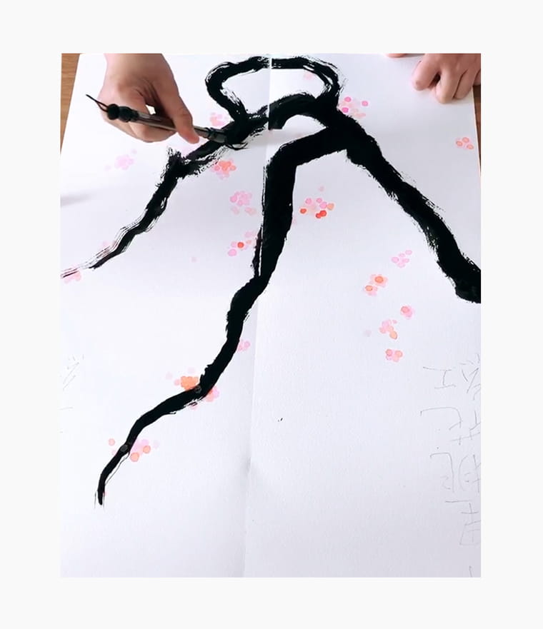 An artist creating a Chinese New Year calligraphy couplet