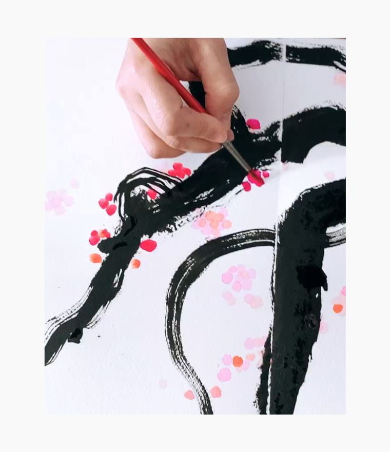 An artist creating a Chinese New Year calligraphy couplet