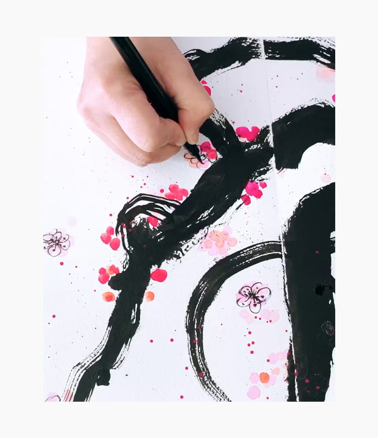 An artist creating a Chinese New Year calligraphy couplet