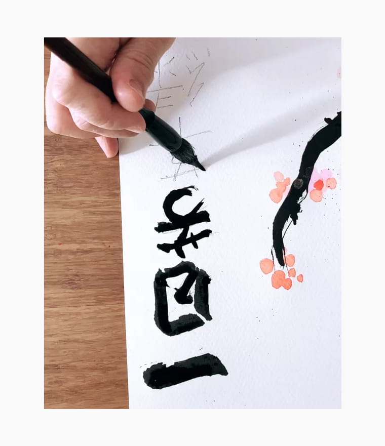 An artist creating a Chinese New Year calligraphy couplet
