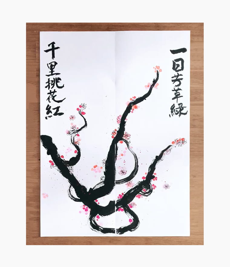 An artist creating a Chinese New Year calligraphy couplet