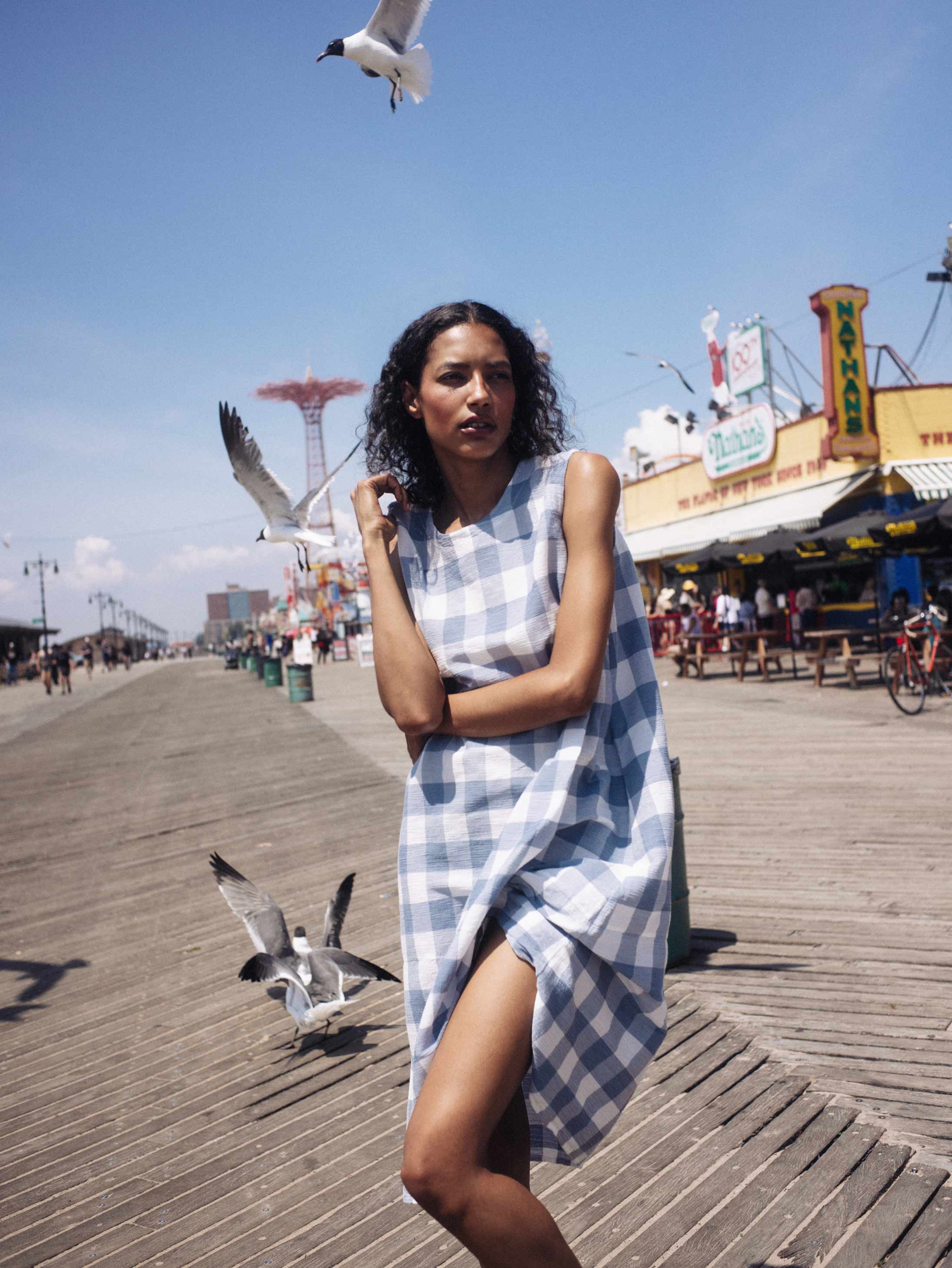 A model poses at COney Island wearing Plantation