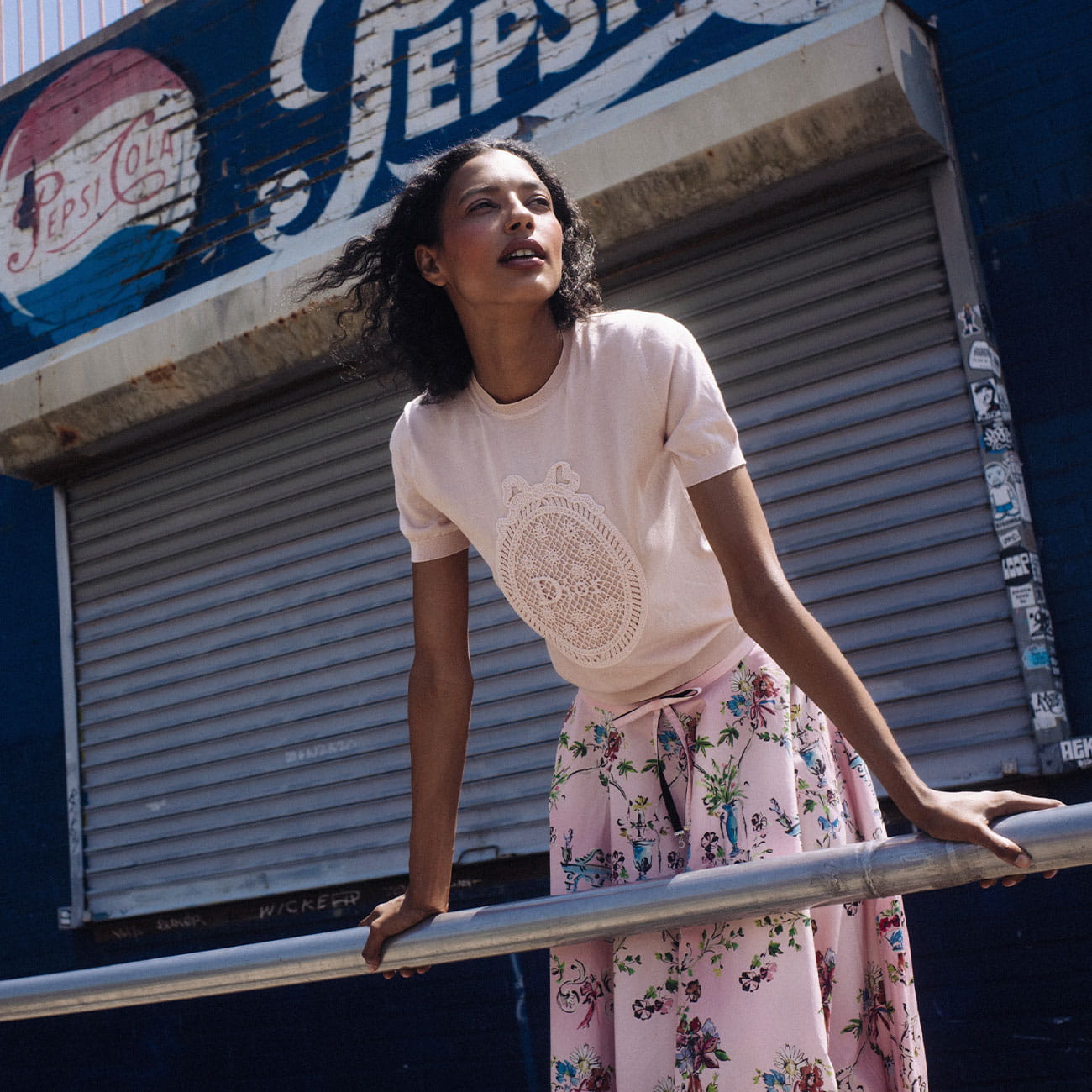 A model poses at COney Island wearing DIOR