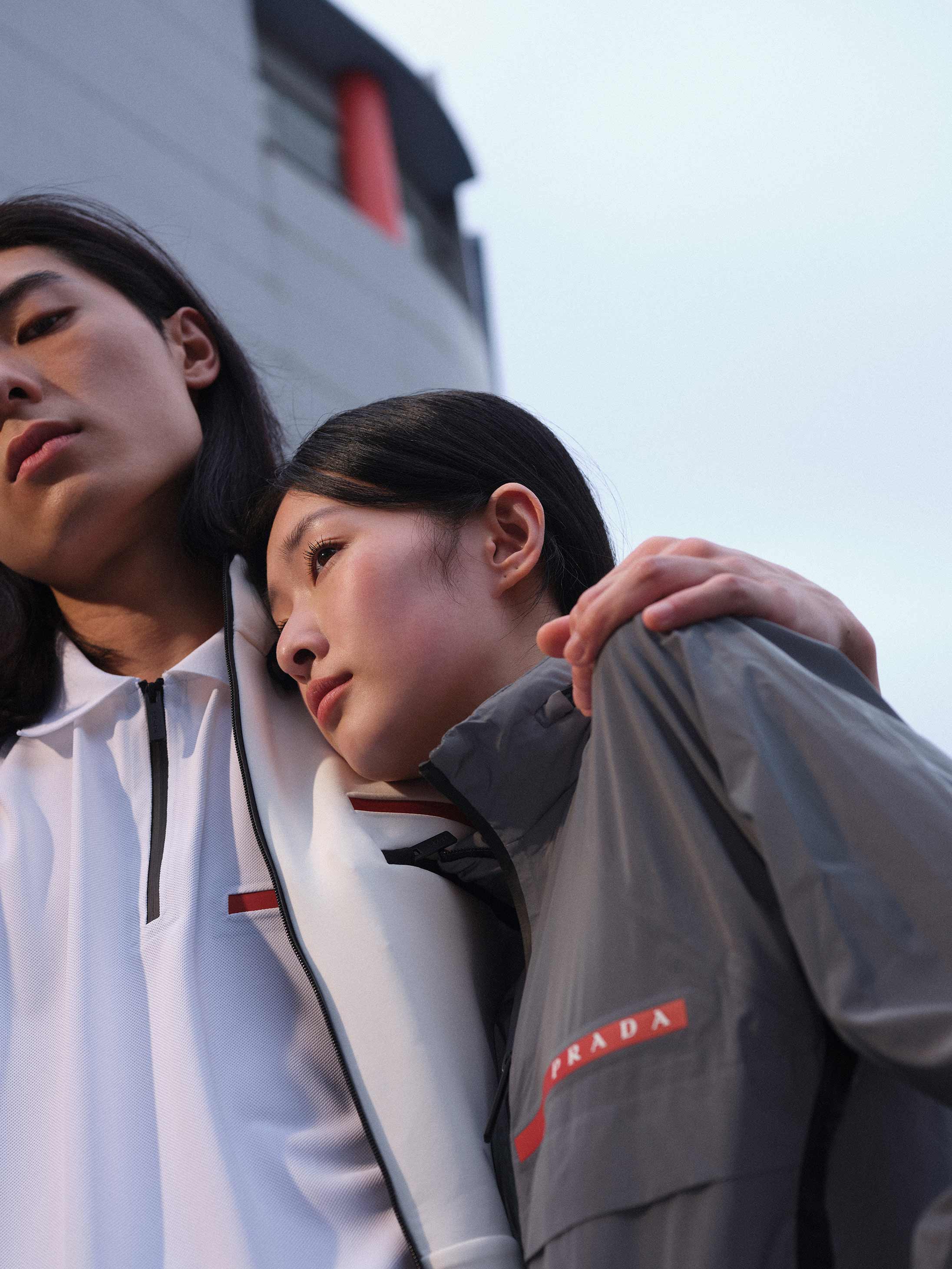 A couple poses in Prada SS2022 available at Pacific Place