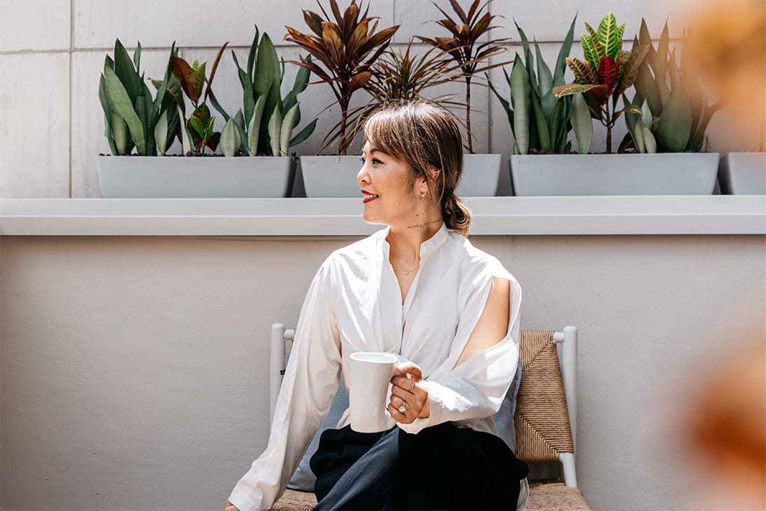 Kaye Dong relaxes on the balcony at The Good Studio