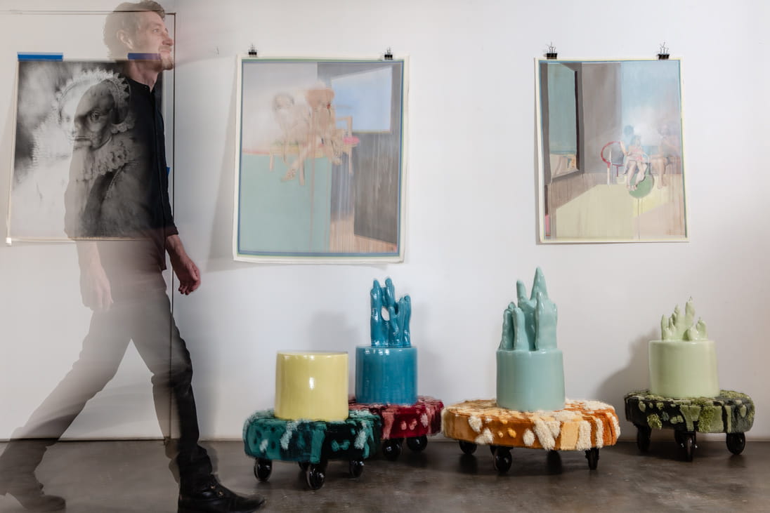 Jesse Mc Lin walks the hallway of his space next to limited-edition experimental pieces under the label Julie & Jesse