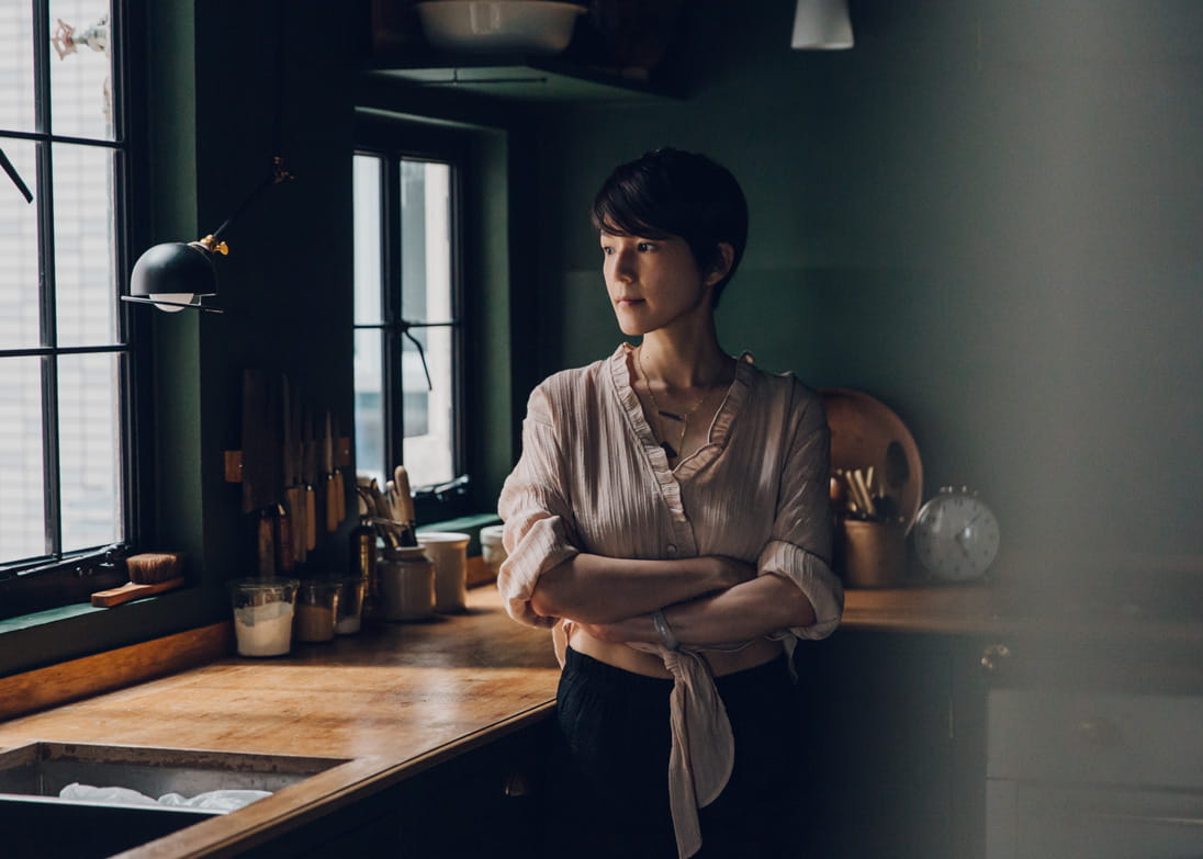 As someone who finds dark spaces calming, Mandy Lee settled on a dark green that predominates through the kitchen spaces