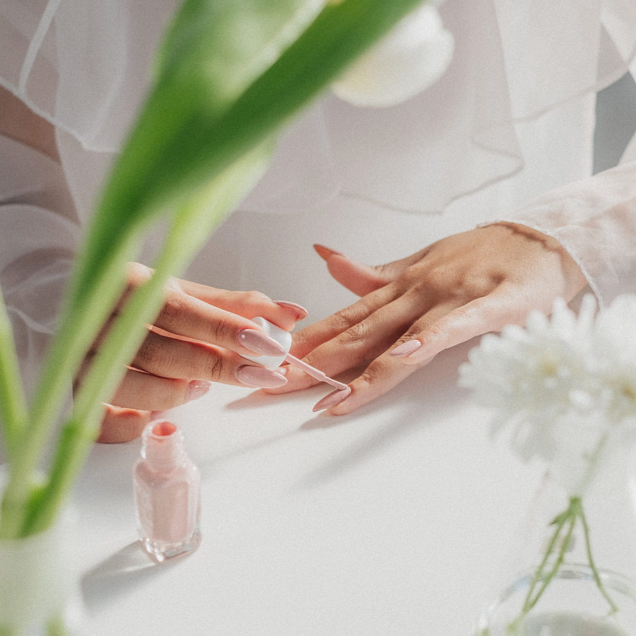 A woman giving herself a manicure with products available at Pacific Place