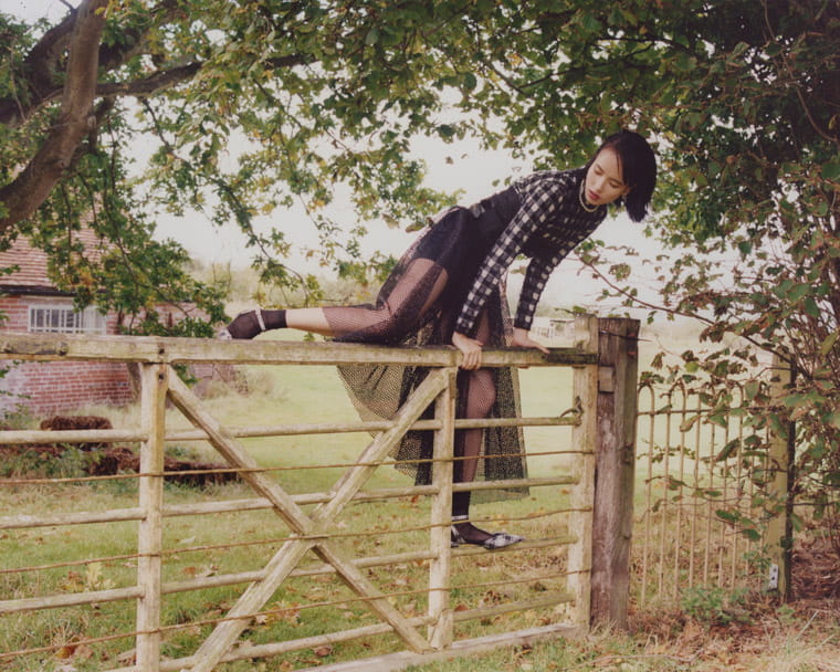 A model jumps a fence in Dior