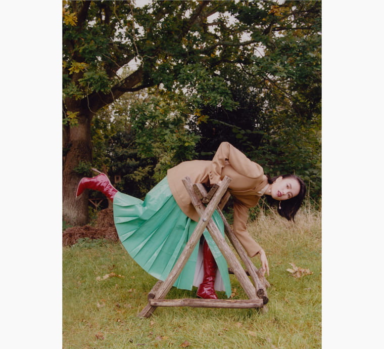 A model playfully poses in the countryside 