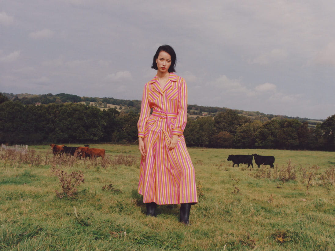 A model playfully poses in the countryside 