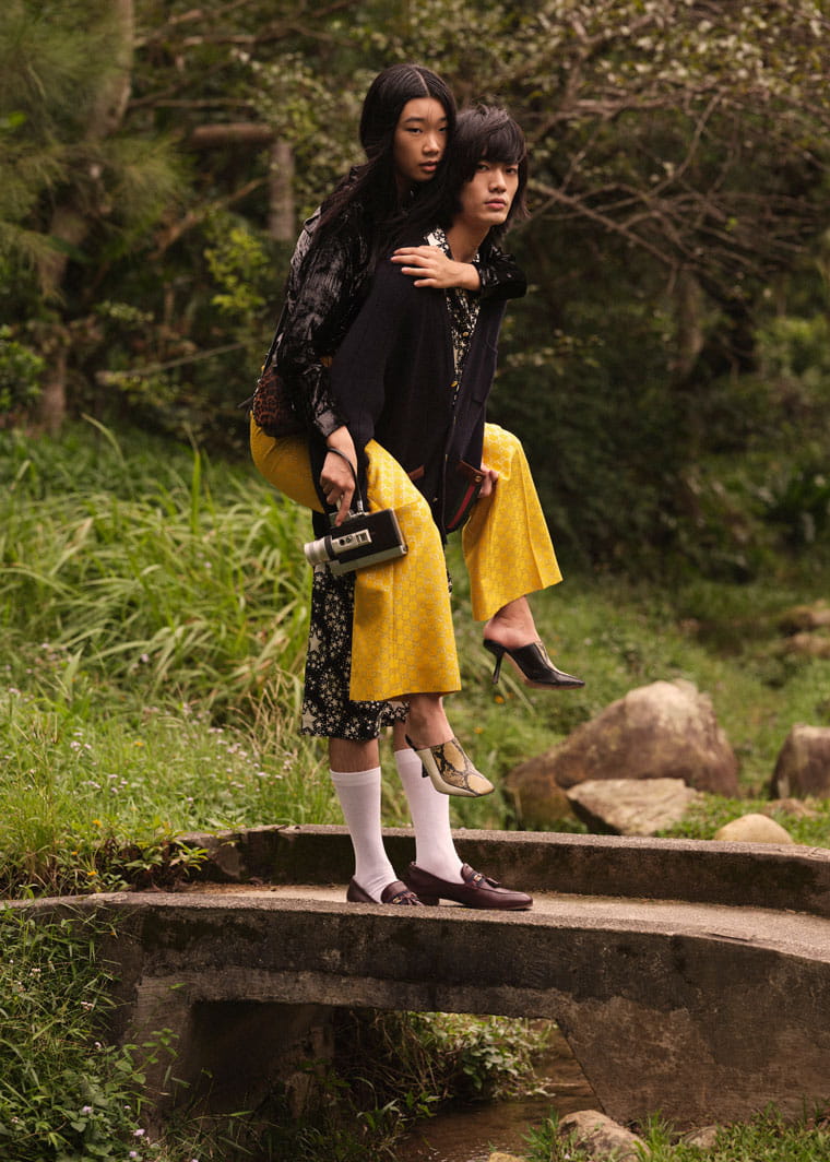 Make and female models pose in Gucci and Jimmy Choo