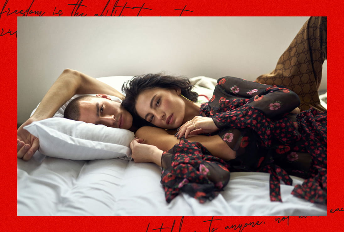 Models lounge of a bed wearing a clash of printed clothing