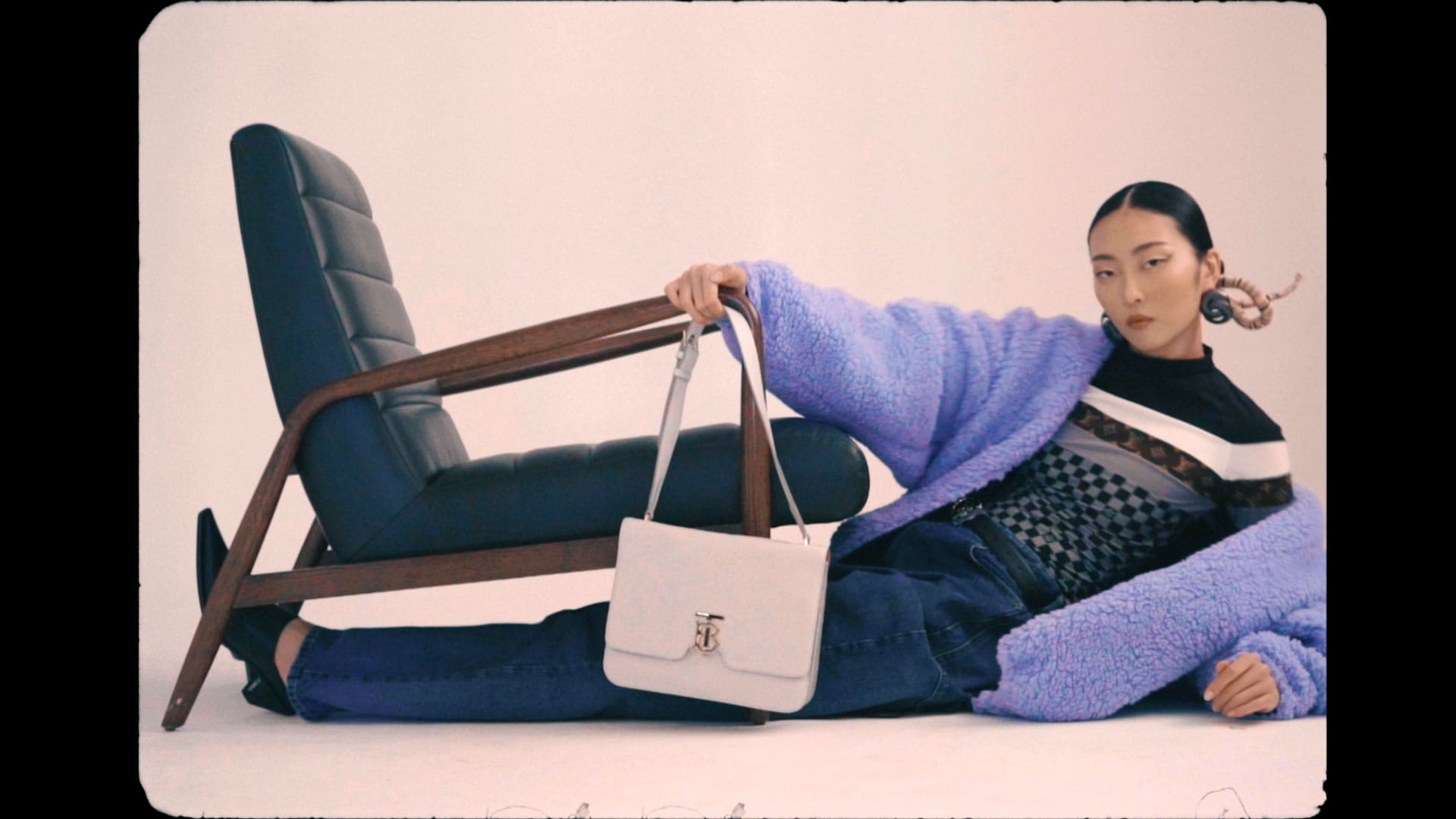 A video of a model lounging in glamour 2020 fashions