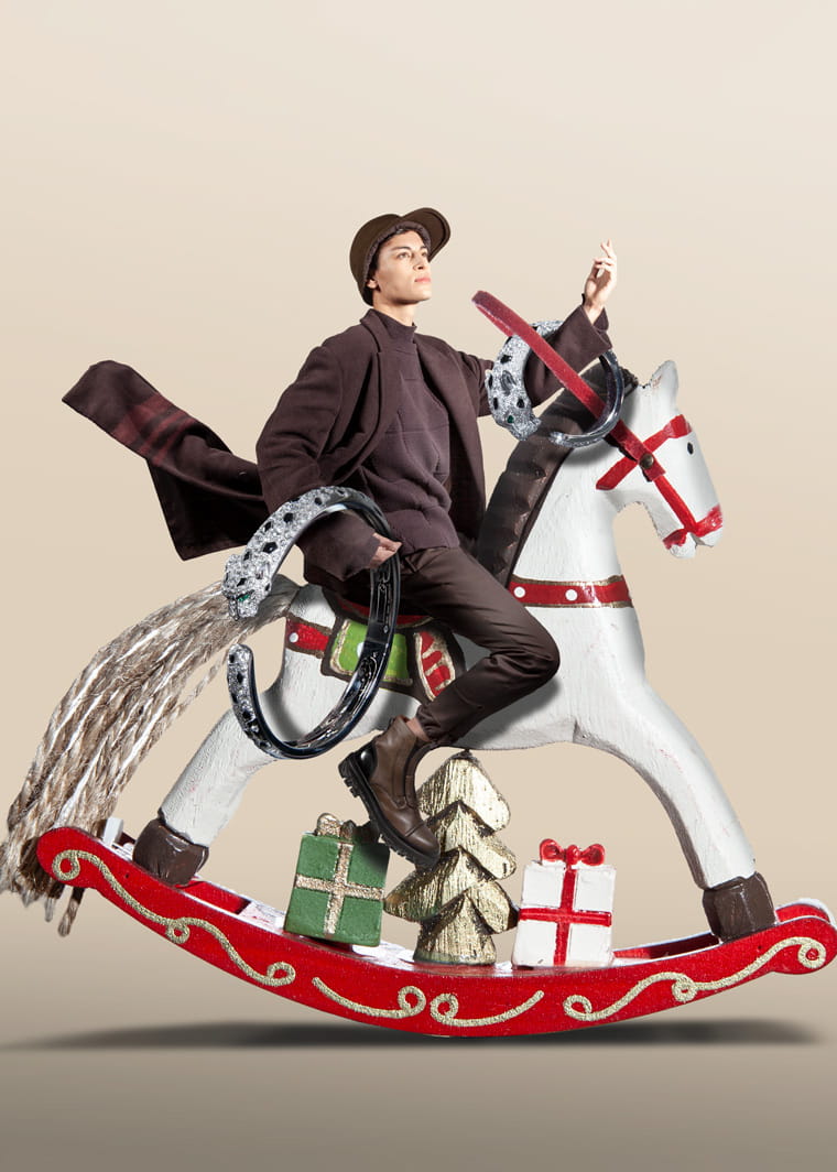 A model on a rocking horse wearing Ermenegildo Zegna