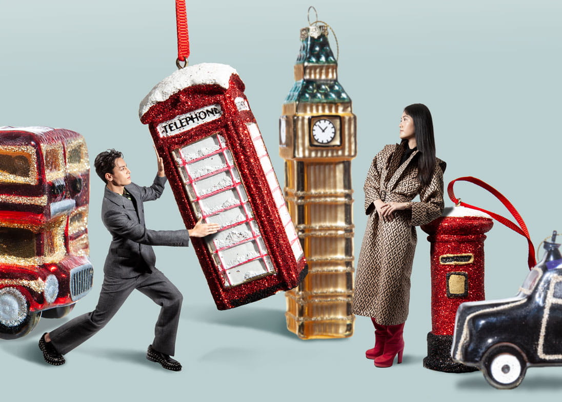 Models play with life-sized Christmas ornaments wearing Prada and Gucci