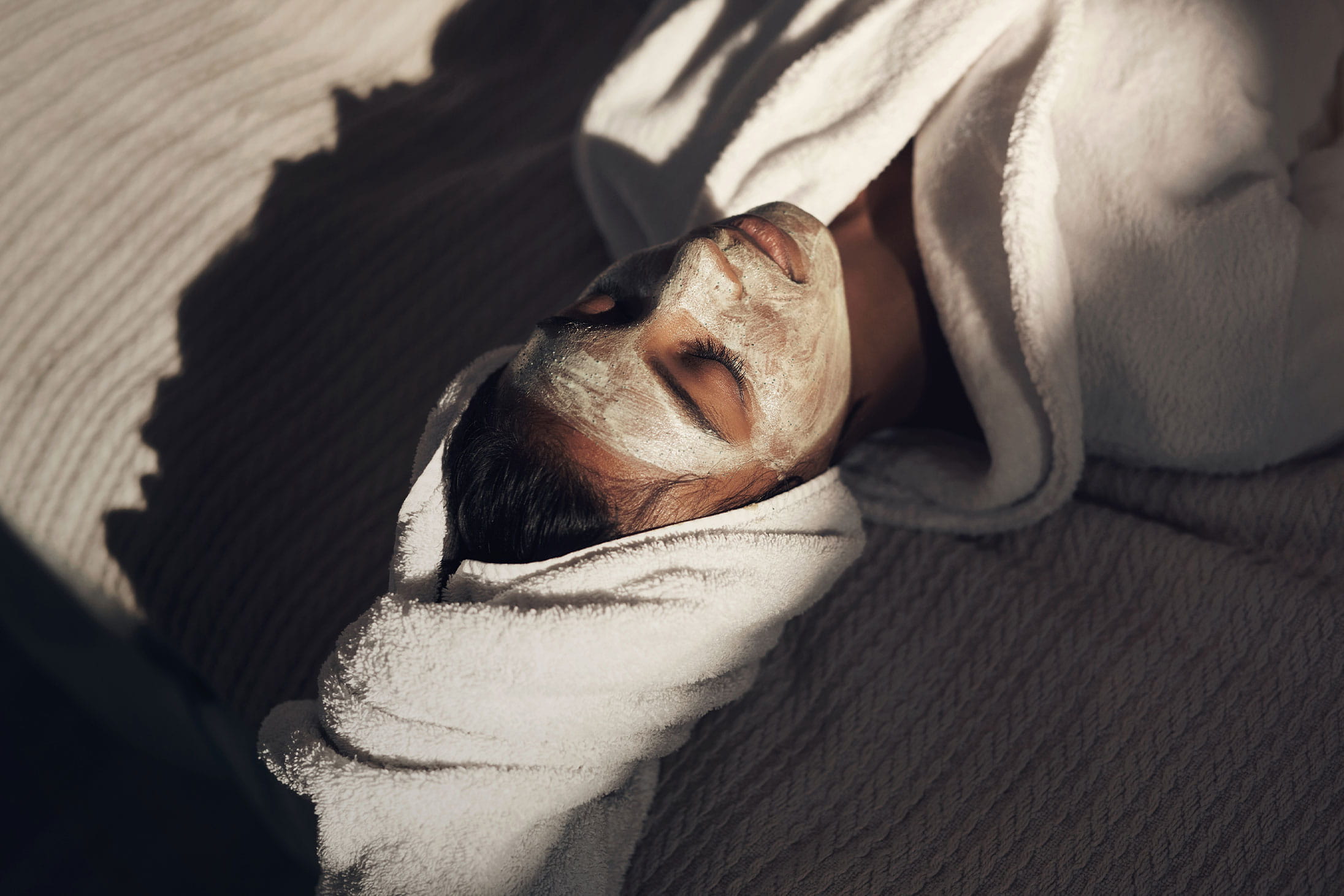 A woman doing a home facial