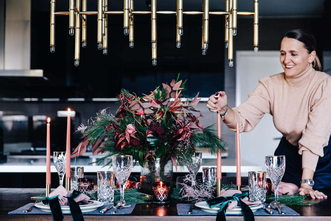 Diane’s foliage-filled tablescape features an Ellermann floral arrangement, Let Your Heart Be Light, along with plenty of pine