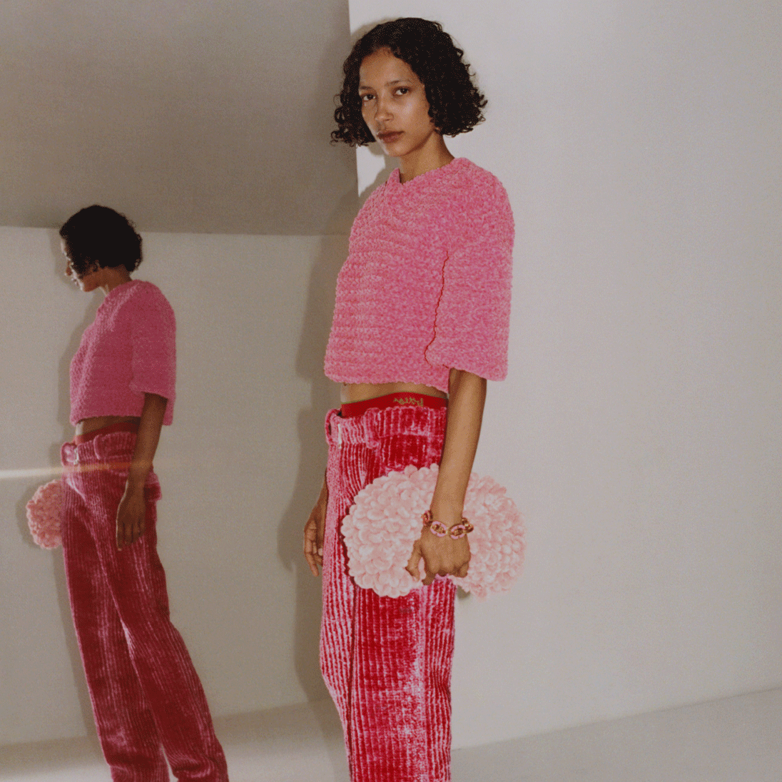 A model holding a Bottega Veneta bag available at Pacific Place
