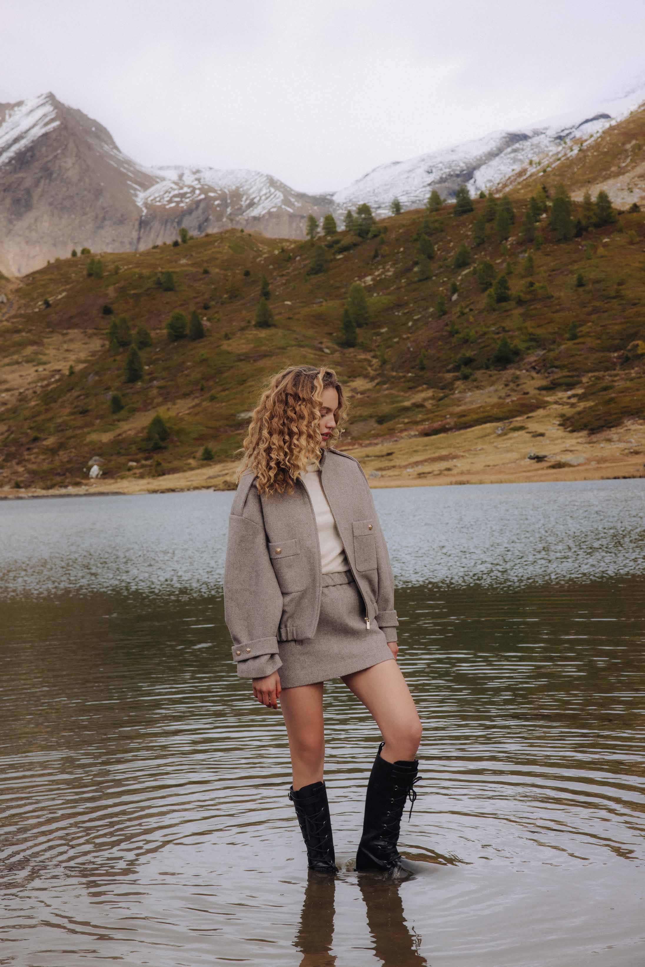 A model poses wearing Maje and Hermès in the Italian Alps