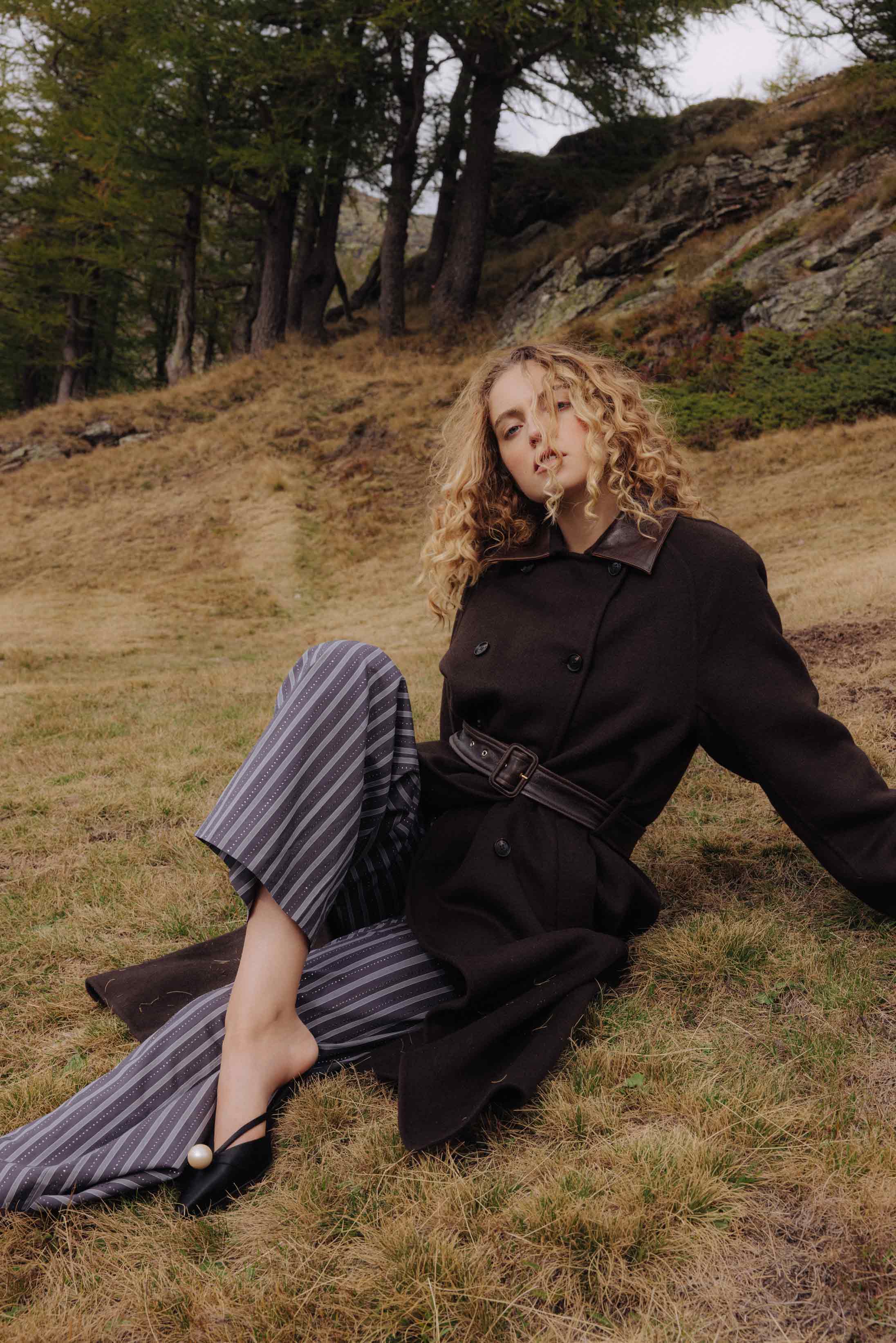 A model poses wearing Sandro and Jimmy Choo in the Italian Alps