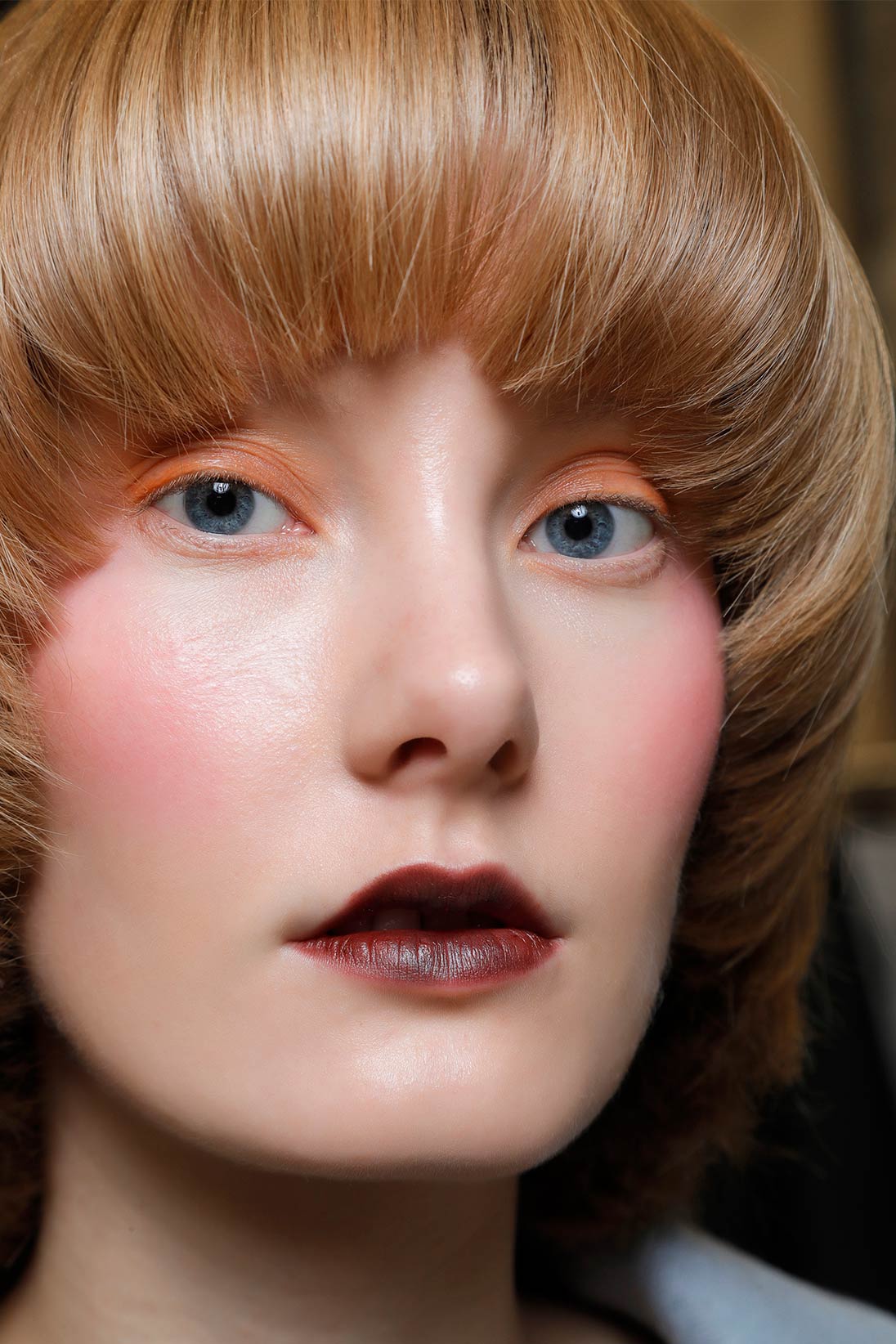 A model wearing dark red lipstick available at Pacific Place
