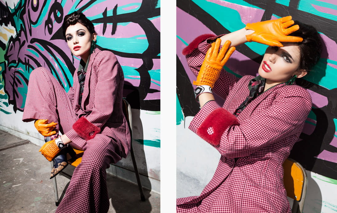 A model slouches on a chair wearing a chequered power suit by Fendi
