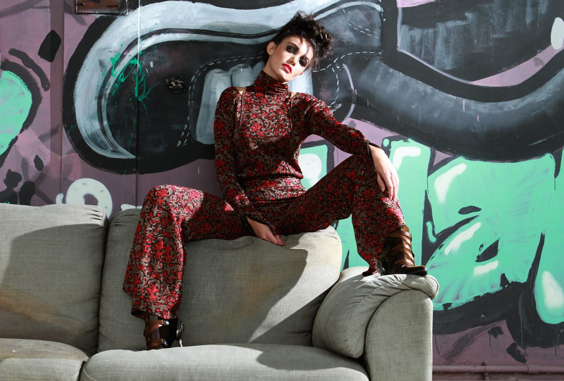 A model lounges on an old sofa wearing the latest head-to-toe look from Chloé