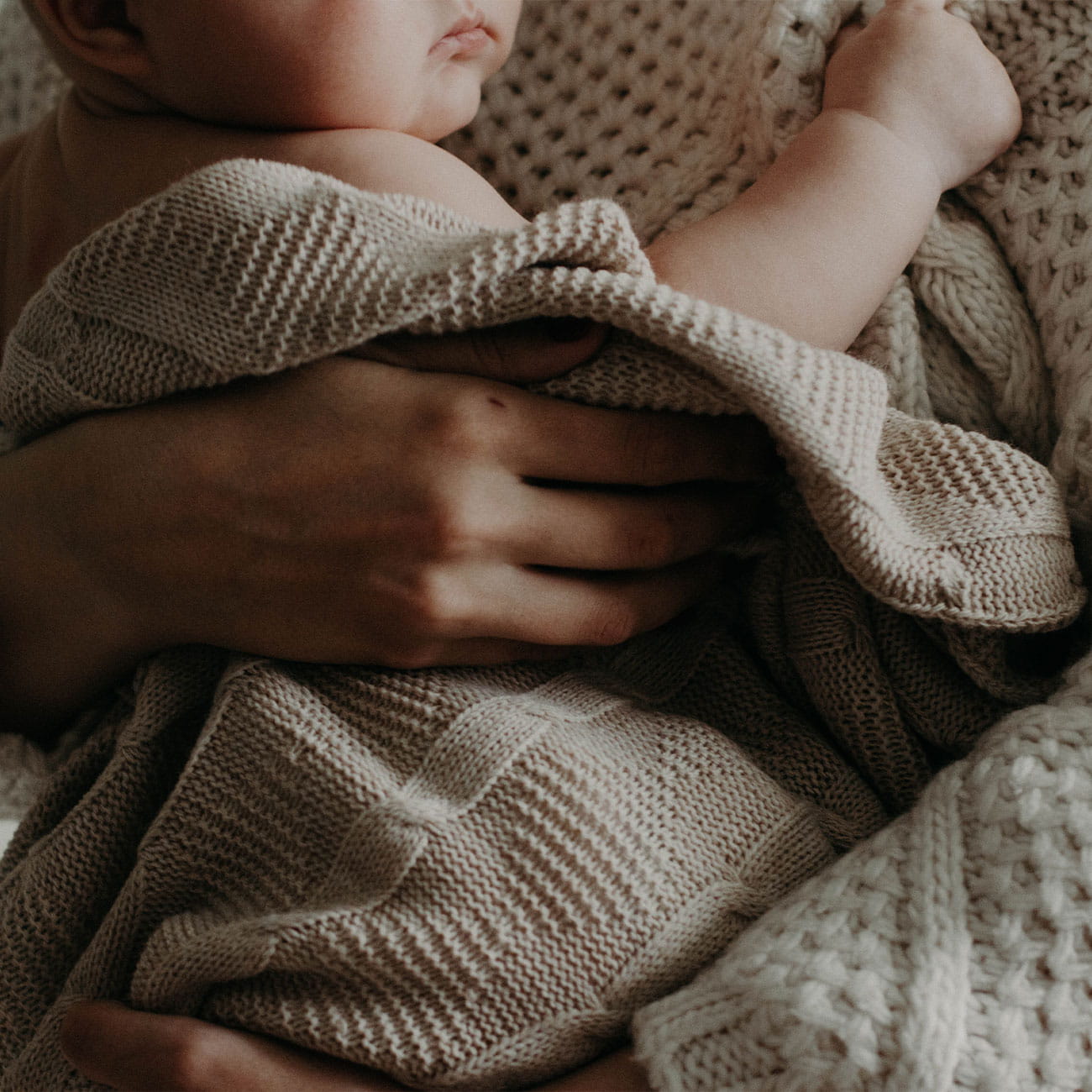A mother holding a baby in celebration of Mother's Day