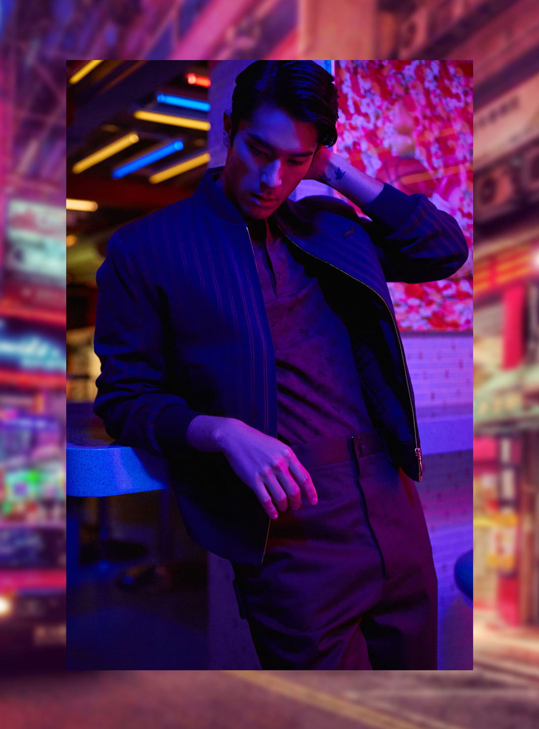A model poses in tailored high-waisted pants from Lanvin, Bottega Veneta shirt and a Kent & Curwen jacket