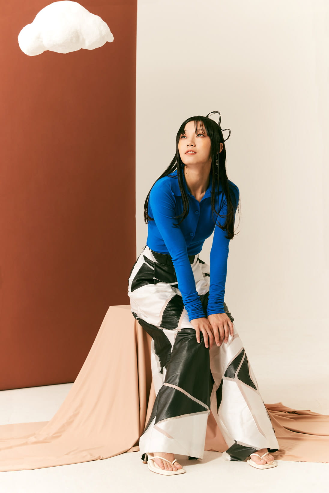 A model poses in Sportmax, Emporio Armani and Chanel