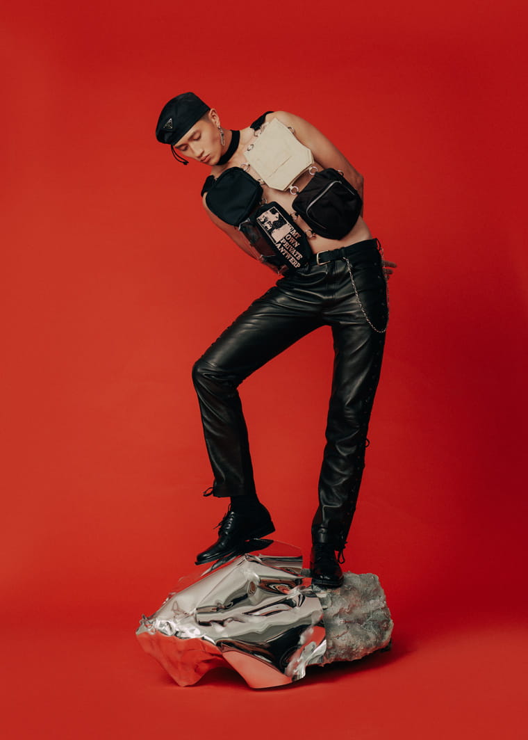A model poses in Versace, Raf Simons, Prada and Balenciaga