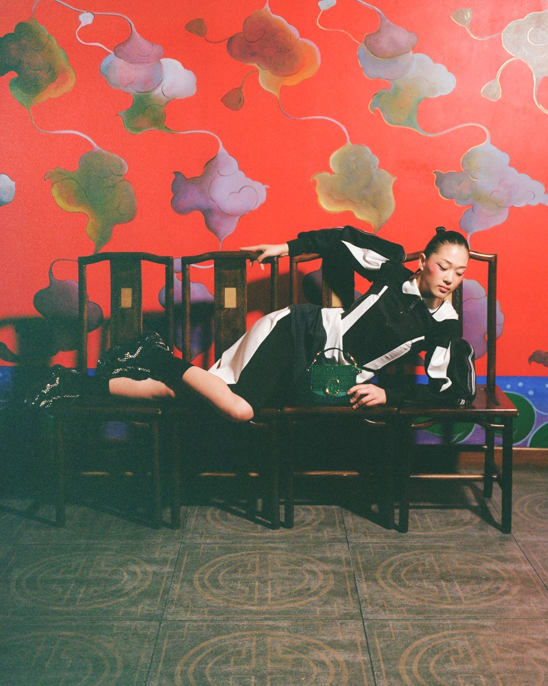 A model lounges in Burberry across four chairs