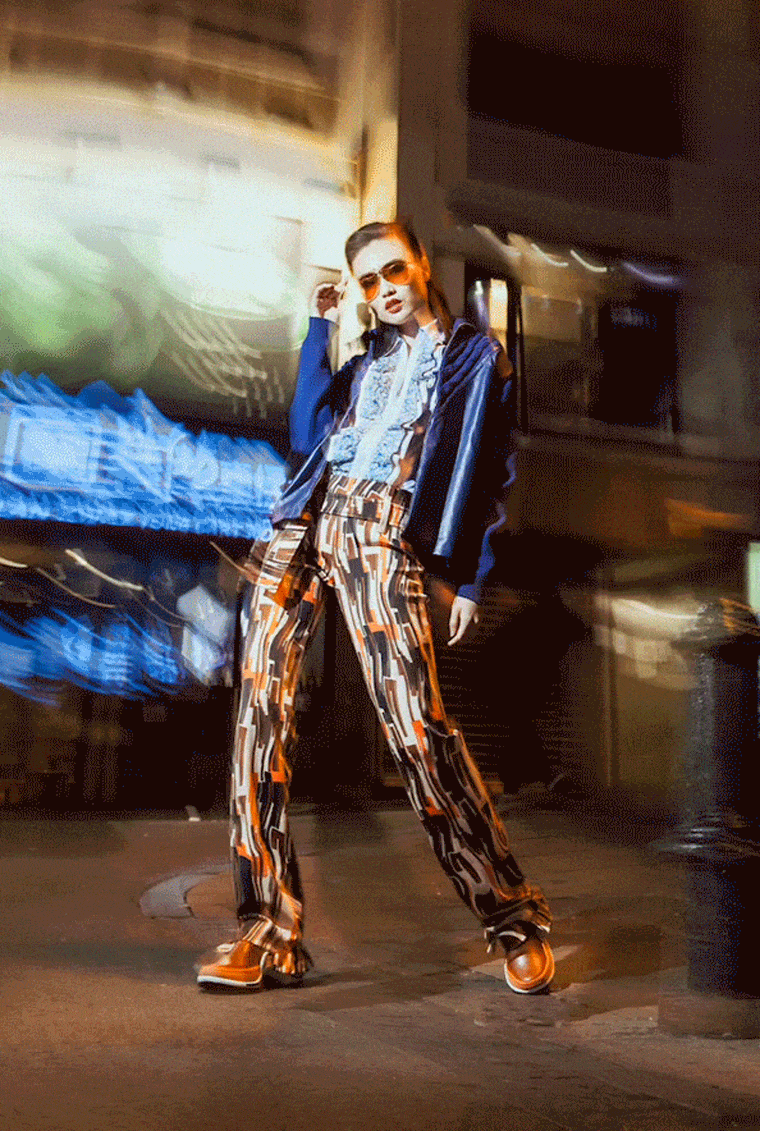 A model poses in a look by Prada on the streets of Hong Kong  