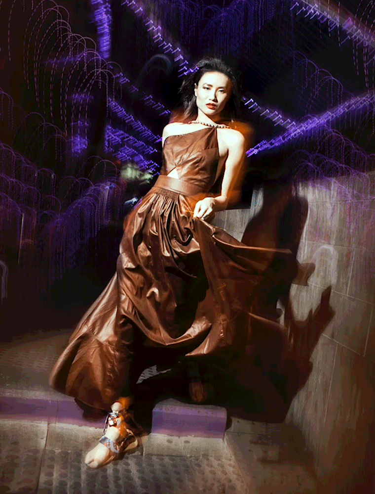 A model poses in Hermès in Hong Kong’s neon-lit night 