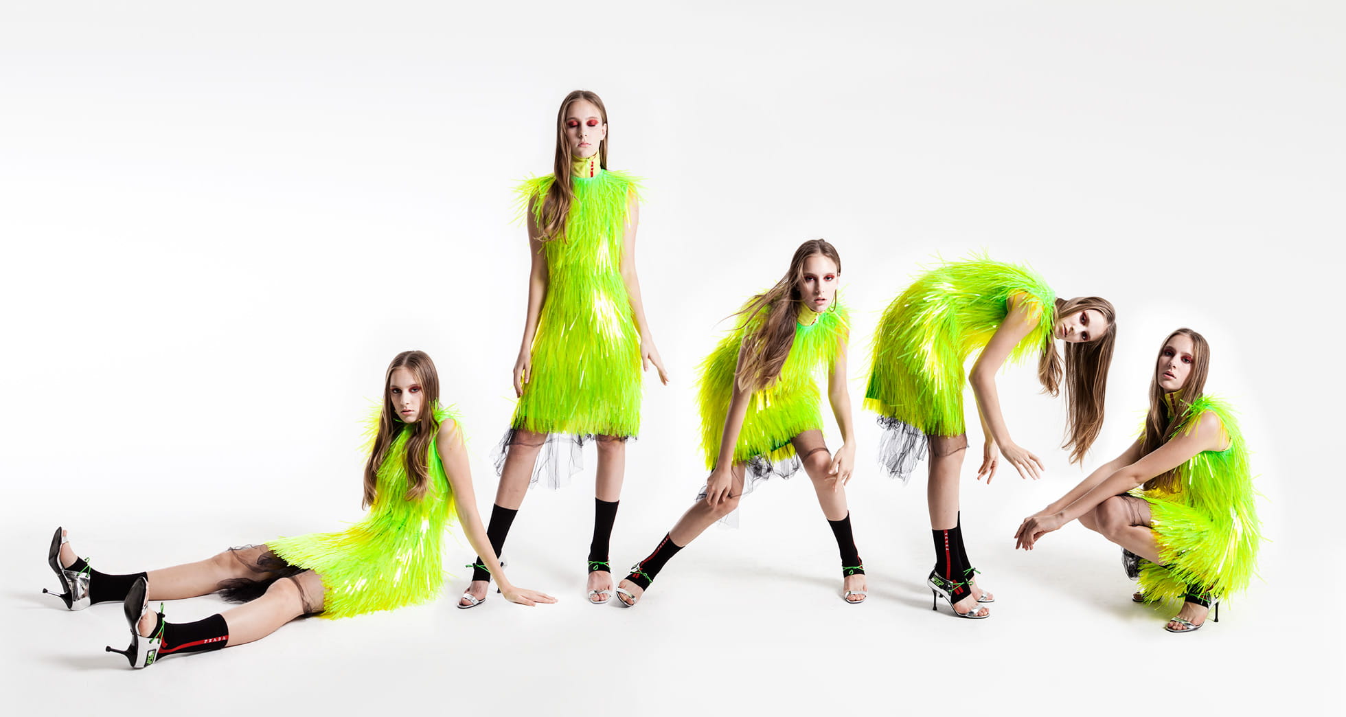 A model poses in a neon fringe Prada look